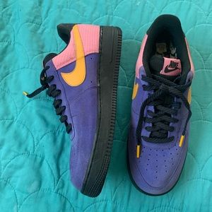 Purple, orange, pink, and black Nike lvl 8’s